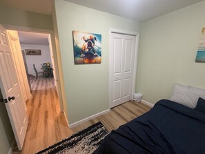 A bedroom with a bed, a door, a painting, and a hallway leading to another room. - Fantastic 2-bedroom apartment with AC in charming Alta (Alta)