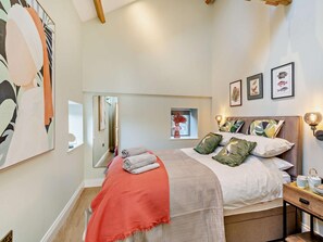 A bedroom with a bed, bedside table, and a mirror. - 1 Bed in Northallerton (oc-93792) (North Cowton)