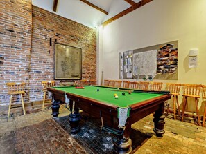 A billiards room with a pool table, wooden chairs, a brick wall, and a map on the wall. - 1 Bed in Doncaster (oc-93768) (Mattersey)