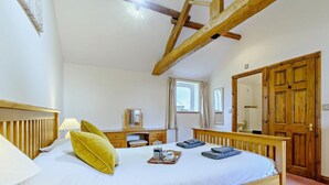 A bedroom with a wooden bed, bedside tables, a dresser, a mirror, and a large wardrobe. - 2 Bed in Doncaster (oc-93770) (Mattersey)