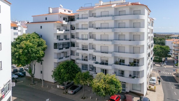 A multi-story residential building with balconies, a parking area, and surrounding greenery. - Lagos Urban Hideout: Discover your own little city retreat in the heart of Lagos (Lagos)