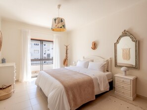 A bedroom with a bed, a dresser, a mirror, and a hanging guitar. - Lagos Urban Hideout: Discover your own little city retreat in the heart of Lagos (Lagos)