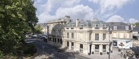 A historic building with a curved facade, large windows, and a corner location.