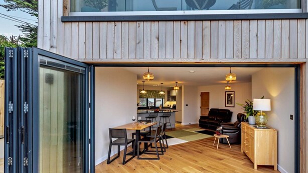 A modern interior with a dining area, kitchen, and seating space. - 1 Bed in Woolacombe (oc-93920) (Woolacombe)