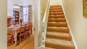 A staircase with carpeted steps and a white handrail, leading to a door with two windows. - 4 Bed in Keswick (oc-93996) (Keswick)