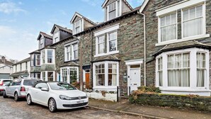 A row of terraced houses with white-framed windows and stone facades. - 4 Bed in Keswick (oc-93996) (Keswick)