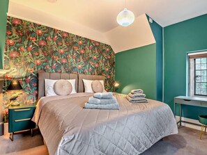 A bedroom with a large bed, a nightstand, a desk, and a window. - 5 Bed in Monmouth (oc-94050) (Monmouth)