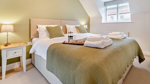 A bedroom with a bed, bedside table, lamp, and a window with a view. - 2 Bed in York (oc-93614) (Beadlam)
