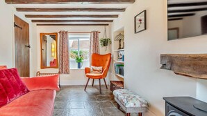 A cozy living room with a fireplace, a sofa, a chair, and a bench. - 2 Bed in York (oc-93614) (Beadlam)