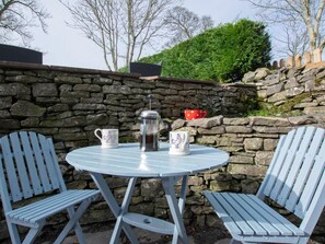 A round table with two chairs, a coffee pot, and two mugs. - 3 Bed in Penrith (oc-74159) (Shap)