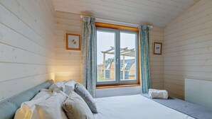 A bedroom with a bed, a window with curtains, and a view of a building outside. - 4 Bed in Shrewsbury (oc-93398) (Sheinton)