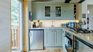 A modern kitchen with a built-in dishwasher, a gas stove, and a microwave.