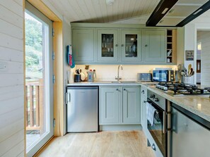 A modern kitchen with a built-in dishwasher, a gas stove, and a microwave.