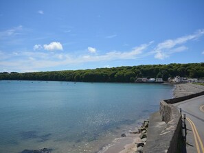 A coastal road with a stone wall on one side and a clear blue sky. - 3 Bed in Haverfordwest (oc-51723) (Saint Annes Head)
