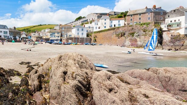 A coastal town with stone buildings, a sandy beach, and a sailboat. - 4 Bed in Gunnislake (oc-77480) (Latchley)