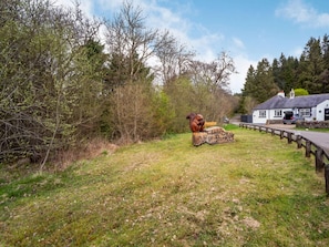 A rustic outdoor area with a wooden sign reading 'Clear Sky Lodge Park' and a squirrel sculpture. - 2 Bed in Hexham (oc-79240) (Kielder)
