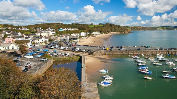 A coastal town with a marina, sandy beach, and residential buildings. - 4 Bed in Tenby (oc-fb104) (Tenby)