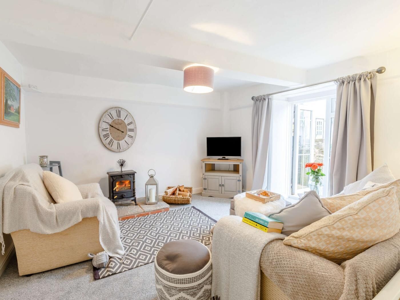 A cozy living room with a fireplace, a television, and a comfortable seating area.