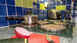 A kitchen with a cutting board, a knife, a pot, a toaster, and a blender on the counter. - 3 Bed in Cromer (oc-88327) (Northrepps)