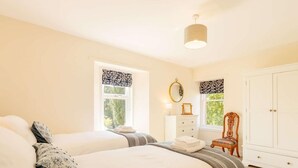 A bedroom with two beds, a dresser, a chair, and a wardrobe. - 4 Bed in Brechin (oc-89698) (Brechin)