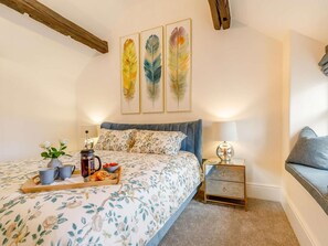 A bedroom with a bed, bedside table, and a nightstand. There are three feather wall art pieces above the bed. - 1 Bed in Hope Valley (oc-89720) (Hope)