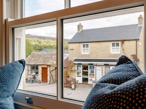 A window with a view of a building and a shop in the background. - 1 Bed in Hope Valley (oc-89720) (Hope)