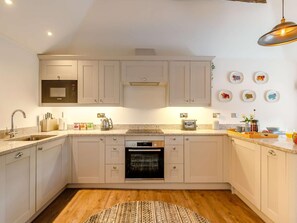 A modern kitchen with a microwave, oven, and toaster. - 1 Bed in Hope Valley (oc-89720) (Hope)