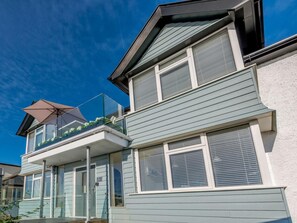 A two-story residential building with a balcony, a sliding glass door, and a window with blinds. - 1 Bed in Hythe (oc-89970) (Hythe)