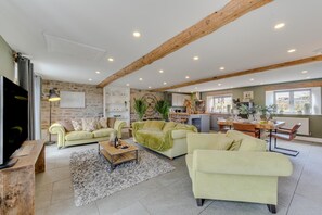 A spacious living area with a large sofa, a coffee table, and a dining area with a table and chairs. - 1 Bed in Richmond (oc-93264) (Hudswell)