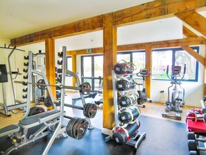 A gym with weightlifting equipment, cardio machines, and large windows. - 3 Bed in King's Lynn (oc-93414) (Middleton)