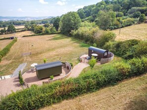 A rural property with a large barn, a covered outdoor seating area, and a paved driveway. - 1 Bed in Hereford (oc-93441) (Little Dewchurch)