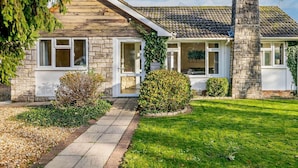 A house with a stone facade, a chimney, and a front porch. - 2 Bed in Christchurch (oc-93458) (Christchurch)