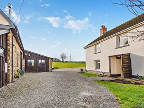 A gravel driveway leading to a property with a stone building and a modern house. - 7 Bed in Bideford (oc-93523) (Weare Giffard)