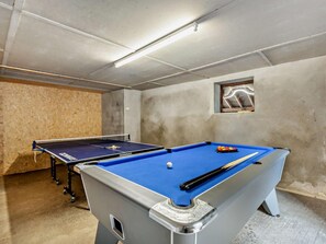 A pool table with balls and cues, a second table in the background, and a small window with a view. - 7 Bed in Bideford (oc-93523) (Weare Giffard)
