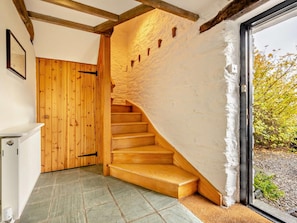 A wooden staircase leading to a room with a white textured wall and a window. - 3 Bed in Keswick (oc-93590) (Threlkeld)