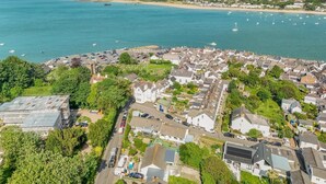 An aerial view of a coastal town with houses, a beach, and boats in the water. - 2 Bed in Appledore (oc-gable) (Appledore)