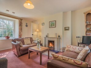 A living room with a fireplace, sofas, a coffee table, and a television. - 4 Bed in Penrith (oc-sz170) (Hartsop)