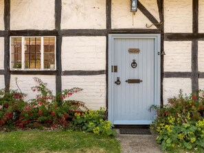 A traditional half-timbered house with a white door, numbered 123, and a small window with bars. - 2 Bed in Salisbury (oc-88922) (Bodenham)