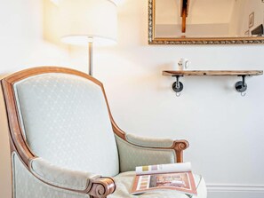 A room with a chair, a lamp, a mirror, and a magazine on the floor. - 2 Bed in Taunton (oc-93581) (Norton Fitzwarren)