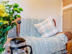 A cozy room with a knitted blanket, a checkered pillow, and a coffee pot on a table. - 2 Bed in Cockermouth (oc-93280) (Bridekirk)