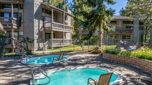 A residential building with a swimming pool, outdoor seating, and a well-maintained garden. - Remodeled 1BD+Loft, Sleeps 5, Walk to Town Center + Pool, Spa, Sauna, & Laundry (Mammoth Lakes)