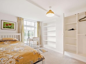 A bedroom with a bed, a desk, a chair, a wardrobe, and a window with curtains. - 2 Bed in Swindon (oc-93489) (Bishopstone)