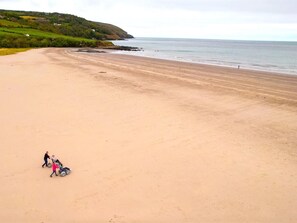 A wide sandy beach with a clear view of the sea and distant hills. - 4 Bed in Llandysul (oc-93546) (Cwmhiraeth)