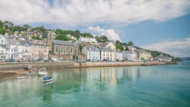 A coastal town with historic buildings, a church, and boats docked along the waterfront. - 2 Bed in Machynlleth (oc-93645) (Glaspwll)