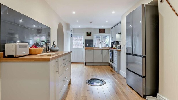 A modern kitchen with a central island, a built-in oven, and a large refrigerator. - 3 Bed in Stockbridge (oc-94143) (Broughton)