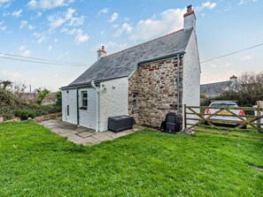 A small stone house with a white exterior, a tiled roof, and a fenced yard. - 2 Bed in Haverfordwest (oc-93577) (Marloes)