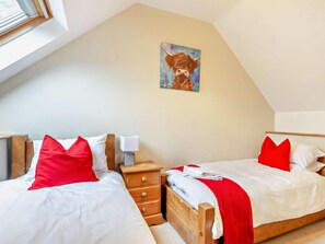 A bedroom with two beds, each with red pillows, a nightstand with a lamp, and a painting on the wall. - 4 Bed in Matlock (oc-93830) (Crich)