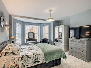 A bedroom with a bed, dresser, television, and a window with blinds. - 2 Bed in Cromer (oc-91297) (Cromer)