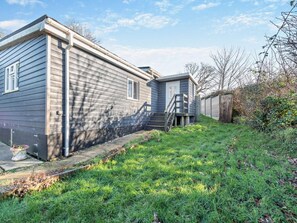 A two-story house with a front porch and a small attached garage. - 2 Bed in Aberaeron (oc-94044) (Ffos-y-ffin)