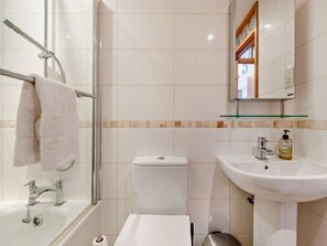 A bathroom with a glass shower enclosure, a white toilet, a sink with a soap dispenser, and a mirror above the sink. - 2 Bed in New Quay (oc-94160) (New Quay)
